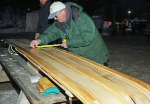Tom Cox inspecting a toboggan